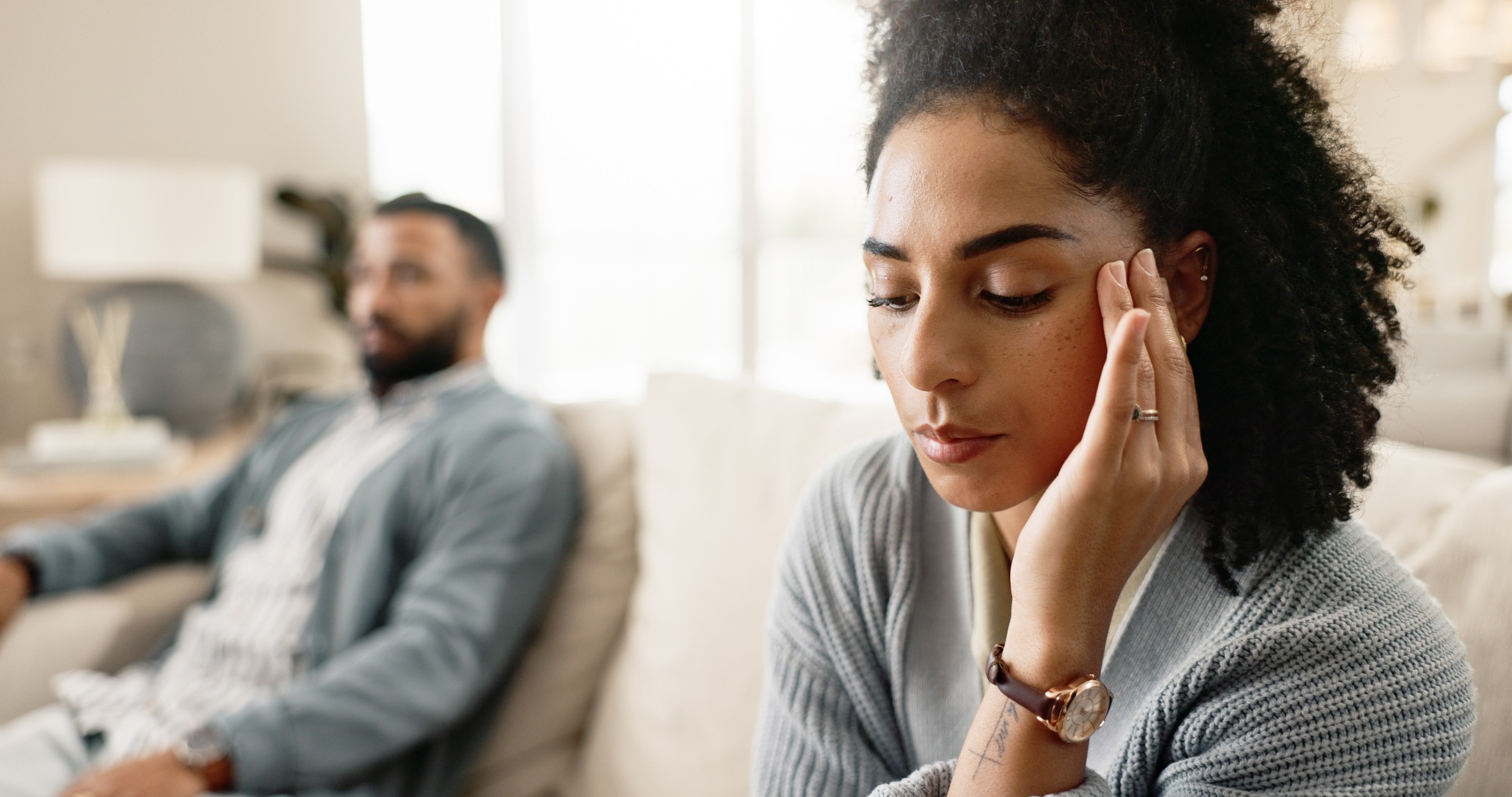 Frustrated couple, headache and sofa with disagreement for fight, divorce or breakup at home. Upset